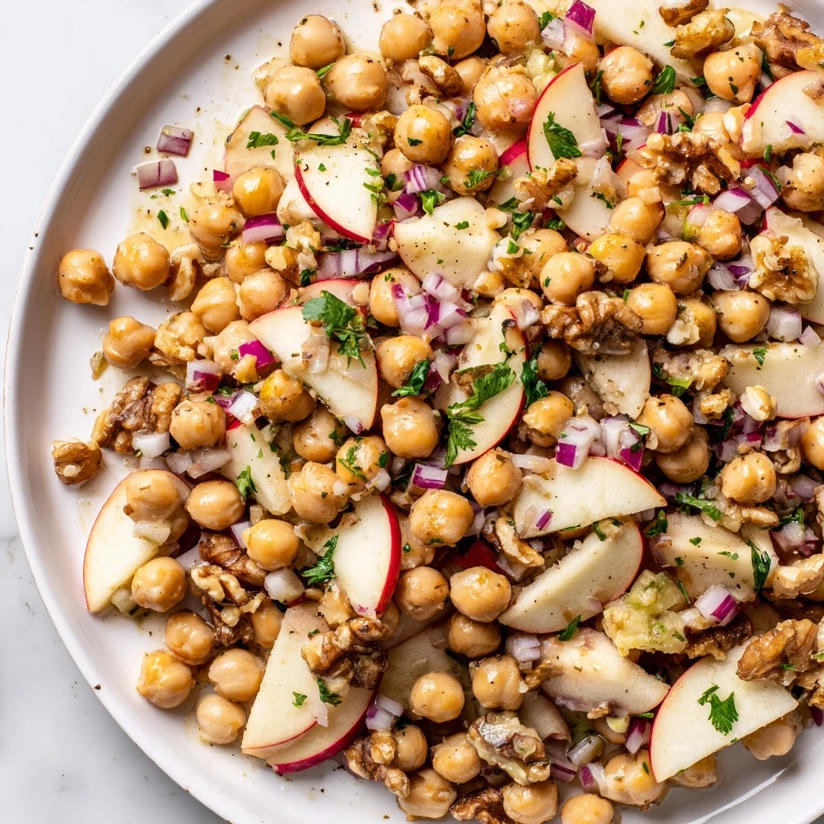 Vibrantly colorful Fall Harvest Apple and Chickpea Salad, ready to eat in a big bowl, a healthy lunch.