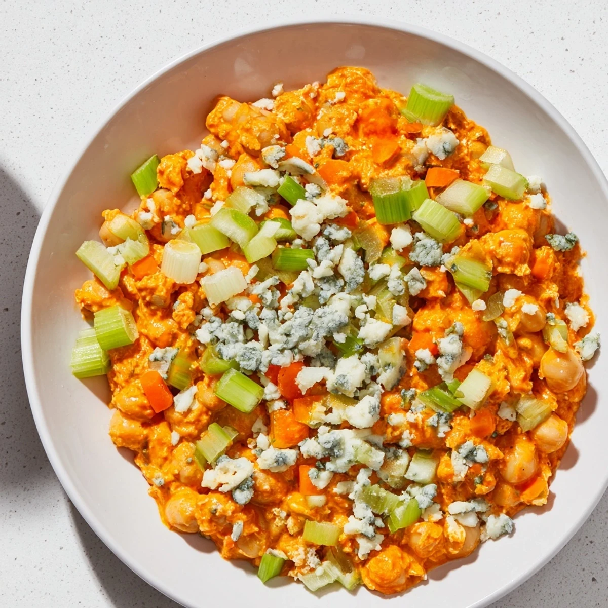 Creamy buffalo chicken bean salad, a vegetarian delight with crunchy veggies and blue cheese.
