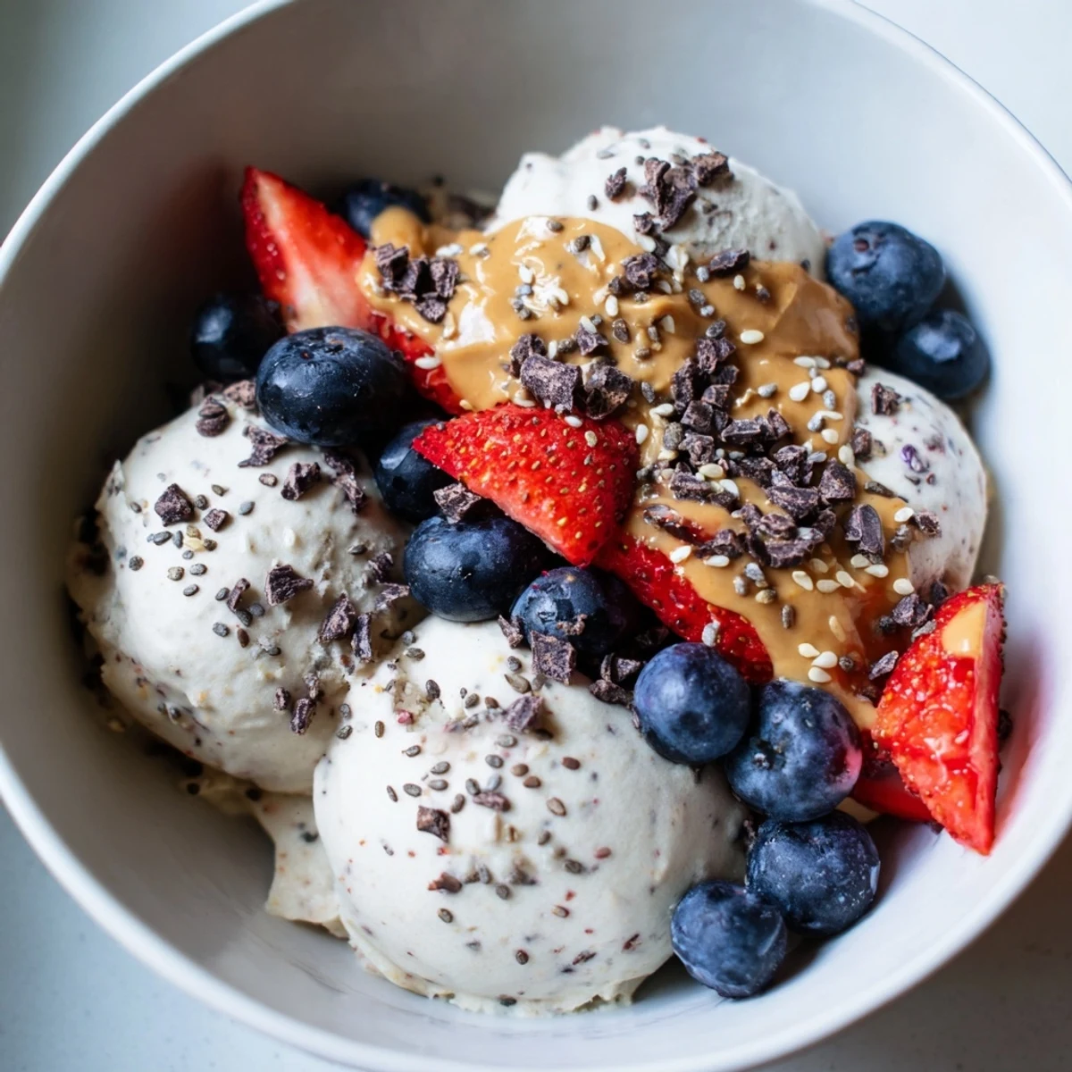 Creamy Protein Ice Cream Bowl, swirled in a bowl, waiting for berries and chocolate chips.