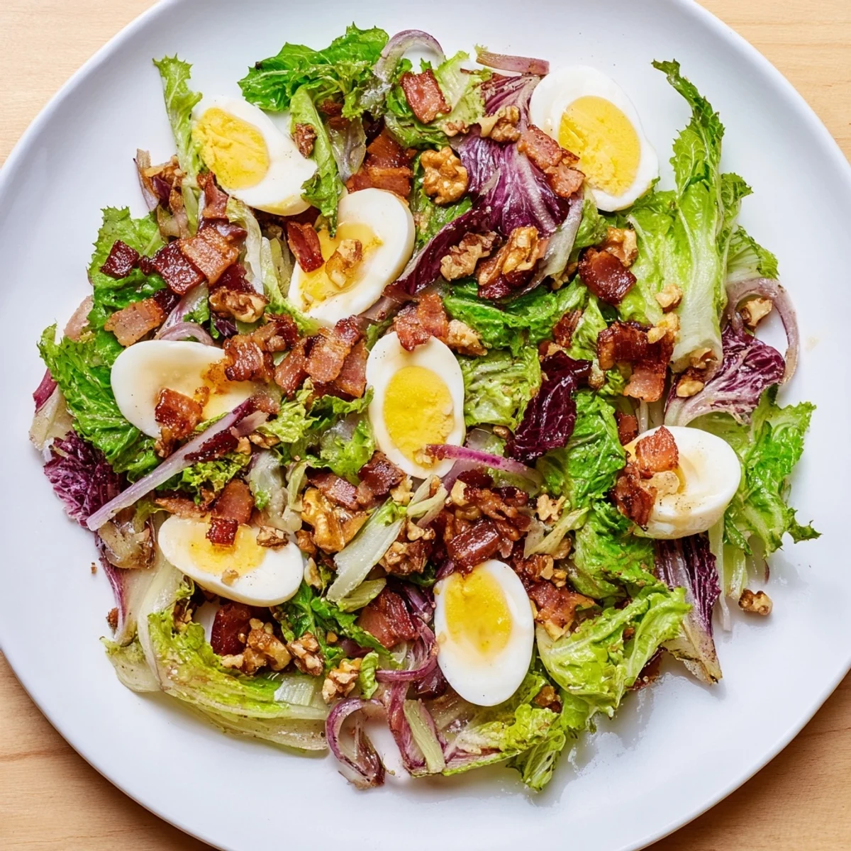 This inviting Bitter Greens Salad presents fresh greens coated with flavorful warm bacon dressing, ready to enjoy.