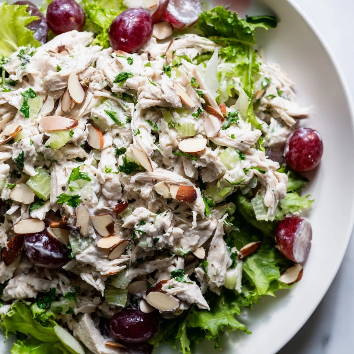 A close-up of a vibrant Crispy Chicken Salad served with crunchy celery and almonds.