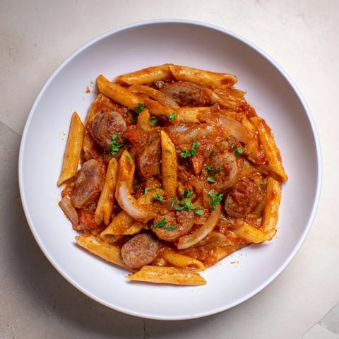 A large bowl of the flavorful One-Pot Currywurst Pasta with parsley garnish, ready to serve.
