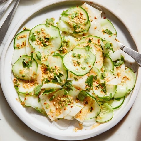 Crisp, layered jicama and cucumber slice stack, drizzled with zesty lime-chili dressing for serving.