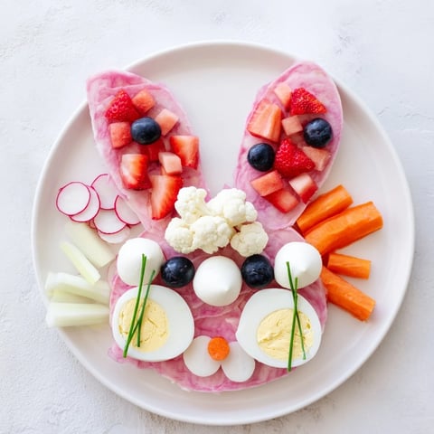 Delicious The Bunny Silhouette party platter, showcasing a vibrant bunny shape with healthy pink and white foods.