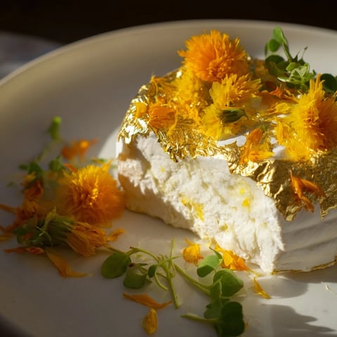 Gold-dusted goat cheese, triple cream brie, and feta compose The Gilded Lily cheese platter, ready to serve.