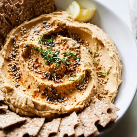A close-up of The Sandstone Canyon appetizer, with layers of hummus and crackers, perfect for sharing.