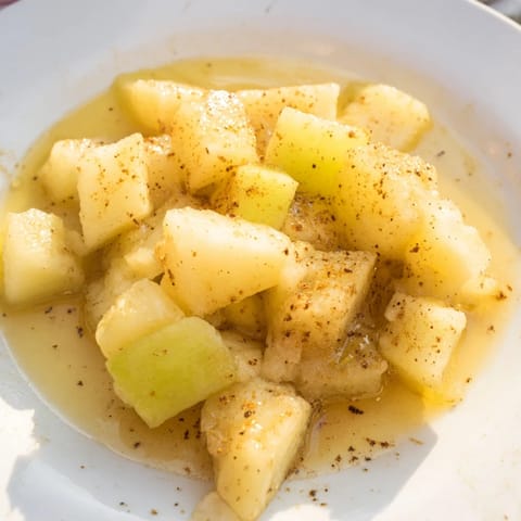 Warm, close-up shot of slow cooker stewed apples, a delightful dessert or topping, ready to serve.