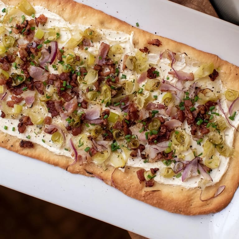 A close-up of the delicious Sheet-Pan Flammkuchen flatbread with visible textures and a delightful aroma.