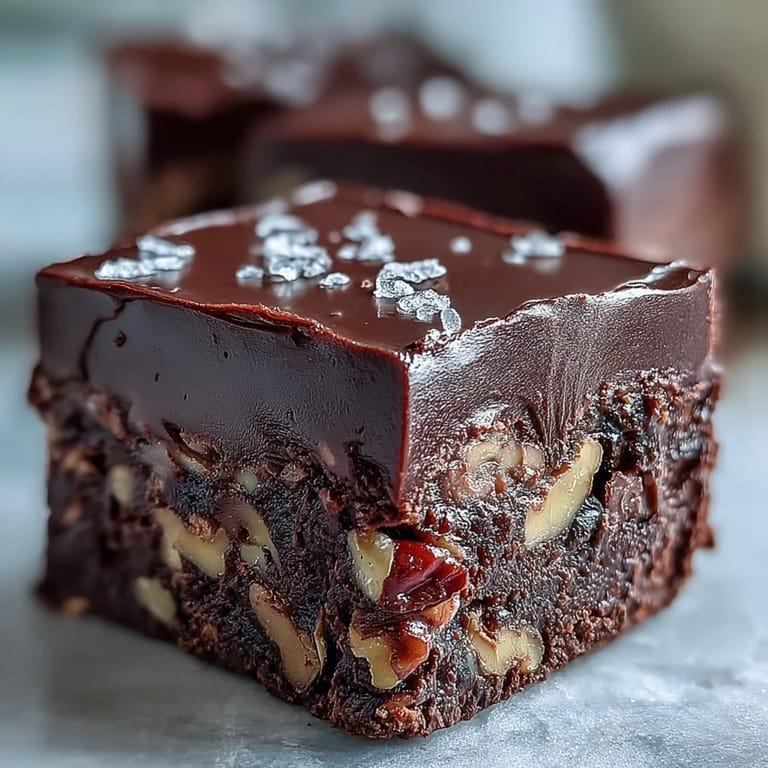 Fudgy Hojicha Fudge topped with sea salt beside a steaming cup of green tea for a cozy dessert pairing.