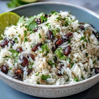 A bright coconut lime rice bowl with black beans and fresh cilantro.